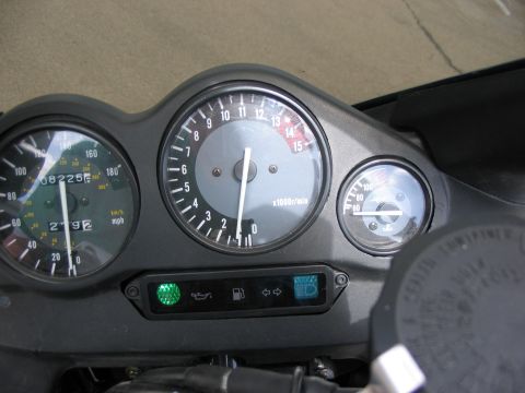 1997 Yamaha YT60 Tri-Moto - The motorcycle's dashboard displays the speedometer, tachometer, and fuel gauge, along with indicator lights for oil, fuel, and headlights.