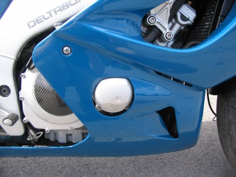 1997 Yamaha YT60 Tri-Moto - Close-up view of a blue motorcycle's fairing, revealing engine components and "DELTABOX" text on the frame.