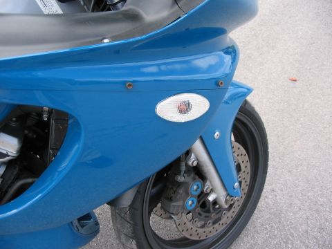 1997 Yamaha YT60 Tri-Moto - Close-up view of the front fairing and wheel of a blue motorcycle.