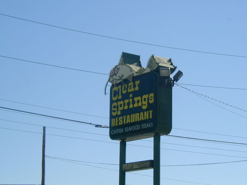 Sign for Clear Springs Restaurant with a catfish graphic, advertising catfish, seafood, and steaks