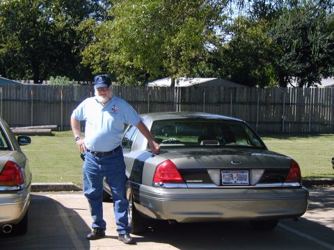 2000 Ford Crown Victoria - A man poses with his Ford Crown Victoria, with another vehicle visible in the background.