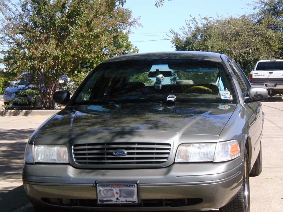 Pewter-gray Ford Crown Victoria sedan front view with Texas plate