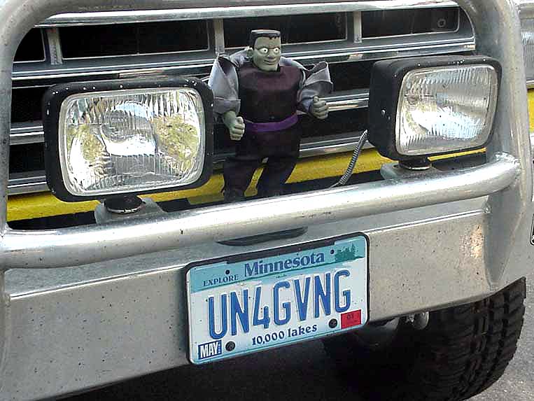 Front chrome bumper with Minnesota UN4GVNG plate, dual lights, and Frankenstein figure in grille