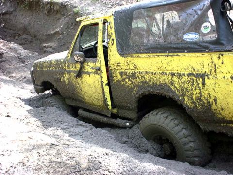 1988 Ford Bronco - This yellow 1988 Ford Bronco is deeply stuck in mud during an off-road excursion.