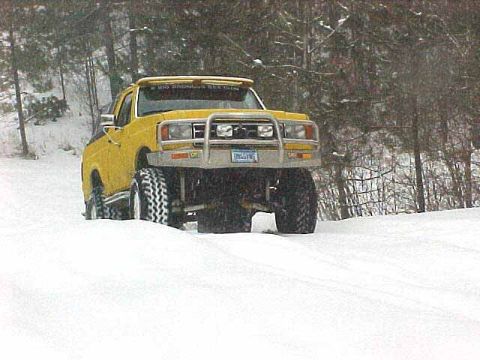 1988 Ford Bronco - This lifted Ford Bronco is navigating through a snowy landscape.