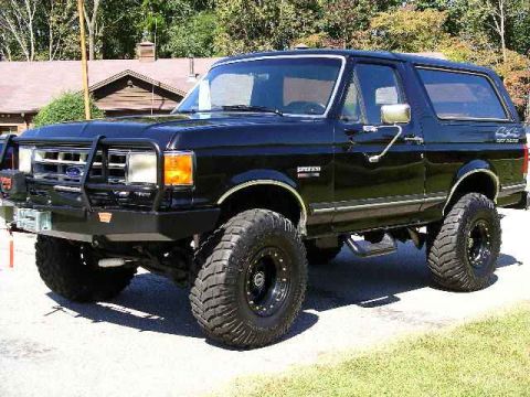 1978 Ford Bronco - This lifted SUV features large off-road tires and a prominent front brush guard.