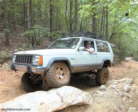 1988 Jeep Cherokee - This 1988 Jeep Cherokee navigates a challenging off-road course through a wooded area.