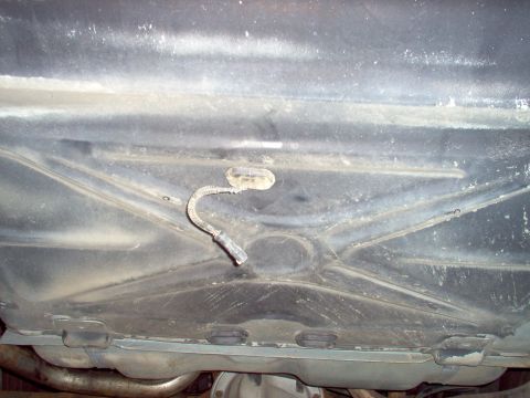 1994 Ford Crown Victoria - I'm using Right Stuff sealant to hold the grommet in place & sealed. The 2 circles on the ribs are where the canister tray rear bolts will…