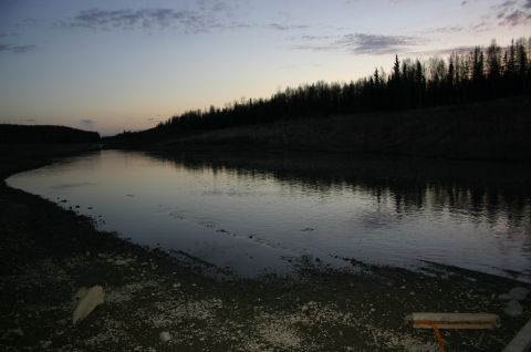2003 Jeep TJ - A tranquil river scene at dusk, with the sky and surrounding trees mirrored in the calm water.