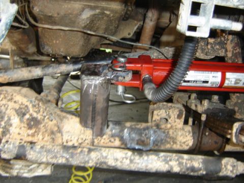 1989 Ford Bronco - Close-up view of a hydraulic ram installed on a vehicle's suspension system.