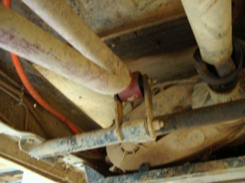 1985 Ford Bronco - Underside view of vehicle parts, including exhaust and driveshaft, with visible Supermotors.net watermark.