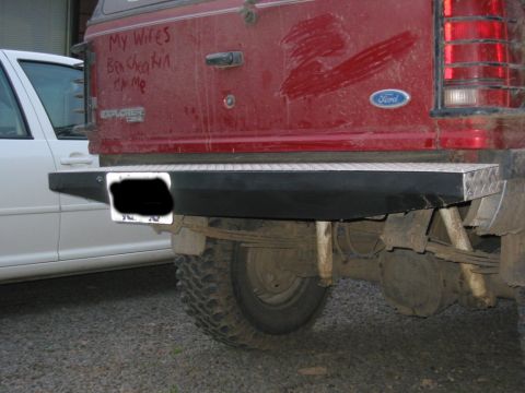 1991 Ford Explorer - Rear view of a 1991 Ford Explorer, its suspension and bumper with a diamond plate step.
