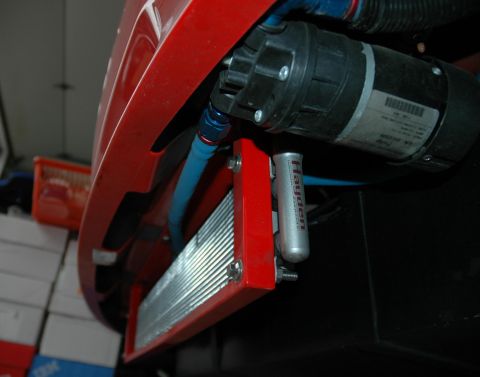 2000 Ford Mustang - Close-up of an aftermarket oil cooler and pump assembly, likely for a performance vehicle.