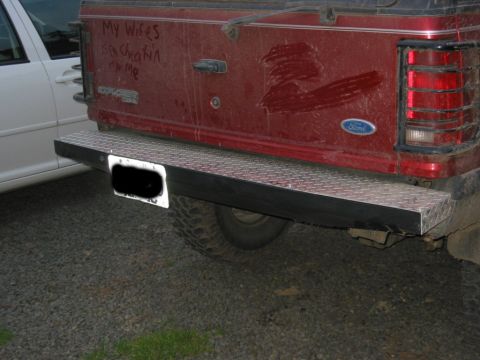 1991 Ford Explorer - The rear of a red 1991 Ford Explorer features a diamond plate bumper and graffiti on the tailgate.