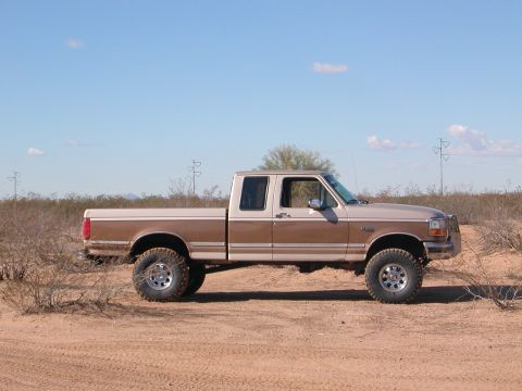1992 Ford F-150 - This two-tone brown 1992 Ford F-150 crew cab pickup truck is shown in a desert environment.