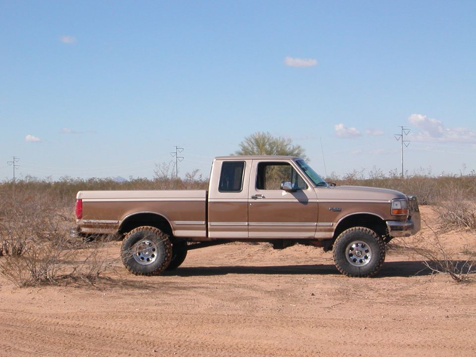 Side view of a 1992 Ford F-150 crew cab pickup truck in a desert landscape