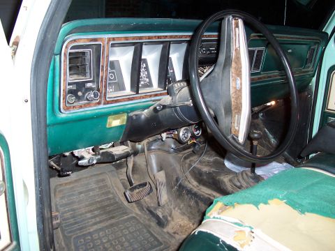 1994 Ford F-150 - Dashboard and interior of an older truck, with a worn seat and visible pedals.
