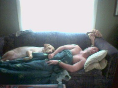 1996 Ford Mustang - A man and his dog are asleep on a couch, with a bright window in the background.