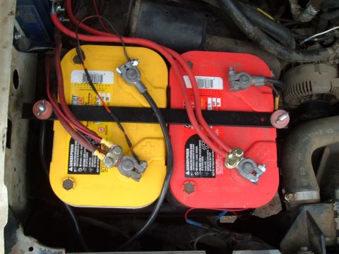 1989 Ford Bronco - Dual car batteries are visible in the engine bay, connected by red and black cables.