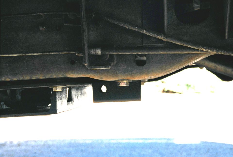 Side view of shackle mount.  The front hole in the mount is where the shackle will bolt in.  The top of the 2x2 was cut back to allow the shackle to swing forward and backward with the axle.