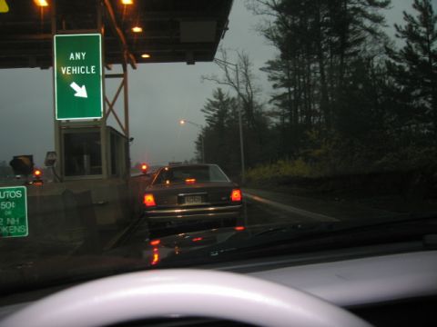 1991 Ford LTD Crown Victoria - A 1991 Ford Crown Victoria LTD passes through a toll booth on a cloudy day.