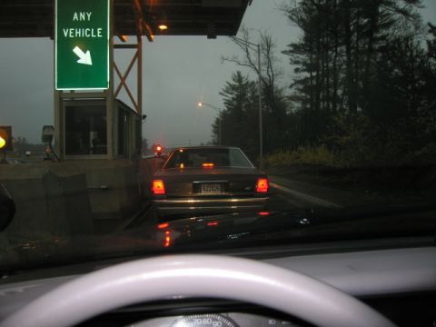 1991 Ford LTD Crown Victoria - A 1991 Ford Crown Victoria LTD approaches a toll booth on a cloudy day.