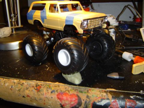 1979 Ford Bronco - A model of a 1979 Ford Bronco is shown with oversized tires and blue tape detailing on its body.