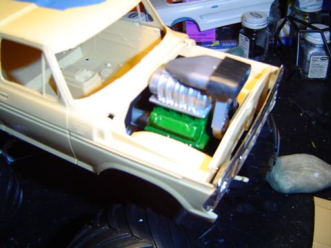 1979 Ford Bronco - A model vehicle's engine bay is shown with a detailed supercharged engine.