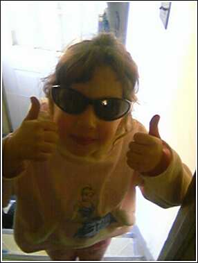 1993 Ford Bronco - A young person in sunglasses and a pink hoodie gives a double thumbs-up gesture.