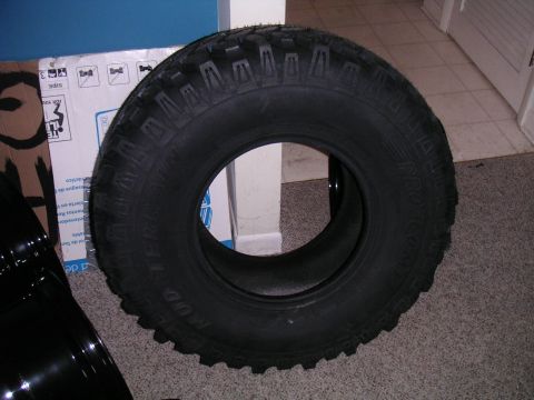 1994 Ford Bronco - A close-up of a Pro Comp Mud Terrain tire, likely for an off-road vehicle, is shown indoors.