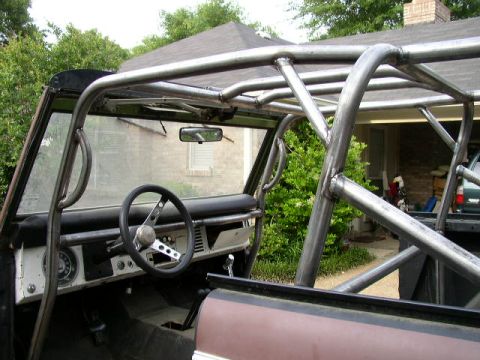 1995 Ford Bronco - The interior of a classic Ford Bronco features a custom-built roll cage for added safety and structural support.