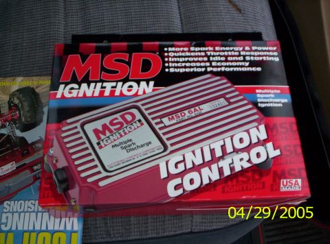 1985 Ford Bronco - MSD Ignition Control box and automotive magazines are displayed on a car seat.