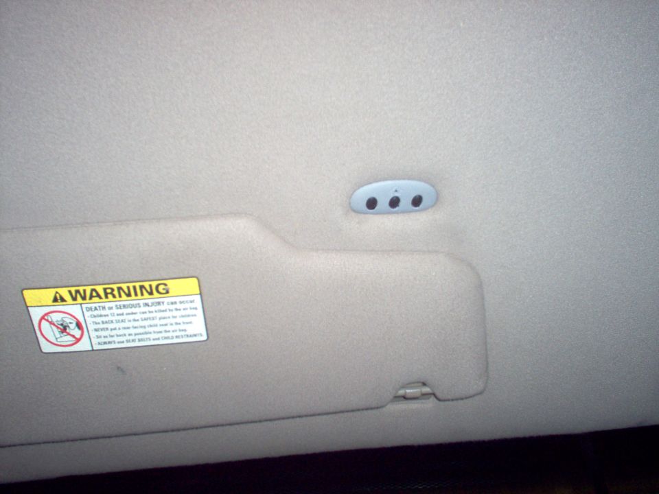 CAUTION: During this procedure, the system that you are programming will be made to operate. Make sure that people or objects are clear of the garage door or gate being programmed.
 
1. Verify the hand-held transmitter is operative.

2. Prepare for programming the universal transmitter by erasing all three channels by holding down the two outside buttons until the red light begins to flash (20-30 seconds). Release both buttons.

3. Select one of the three universal transmitter channels to be programmed by pressing the desired button.

4. Hold the end of the hand-held transmitter 25-51mm (1-2 in) from the front surface of the universal transmitter so that the red light can still be seen.

Note: During programming, the hand-held transmitter may automatically stop transmitting after two seconds, which may not be long enough to program the universal transmitter. If programming this type of hand-held transmitter, continue to hold the button on the universal transmitter while re-pressing the hand-held transmitter button every two seconds (Canada only).
 
5. Use both hands to press the hand-held transmitter button and the desired button on the universal transmitter. Do not release either button.

6. Hold down both buttons until the red light on the universal transmitter flashes, first slowly and then rapidly. Release both buttons when the rapid flashing begins. The universal transmitter has successfully learned the new frequency signal and can be used in place of the hand-held transmitter(s).

Note: If the hand-held transmitter appears to program the universal transmitter but does not open the garage door, the garage door opener may have a "code protected" or "rolling code" feature.
 
7. To operate, simply press the appropriate button on the universal transmitter. The red light is on while the signal is being transmitted.

Training a Garage Door Opener Equipped With "Rolling Codes"

1. Program the hand-held transmitter to the universal transmitter:

2. Train the garage door opener receiver to recognize the universal transmitter.
 
 a) Remove the cover panel from the garage door opener receiver.
 
 b) Locate the training button on the garage door opener receiver. Location and color of the button may vary by garage door opener manufacturer. Refer to the garage door opener instruction manual or call HomeLink® customer assistance at 1-800-355-3515.
 
 c) Press the training button on the garage door opener receiver for 1-2 seconds.
 
 d) Press the programmed universal transmitter button for as long as the universal transmitter red light flashes (1-2 seconds). Release the button and re-press the button to confirm that the universal transmitter is trained to the receiver.
 
 e) The garage door opener should recognize the universal transmitter.
 

Erasing Channels

Note: Individual channels cannot be erased, but can be reprogrammed using the procedures for programming.
 
1. To erase all three programmed channels, hold down the two outside buttons until the red light begins to flash (20-30 seconds). Release both buttons.