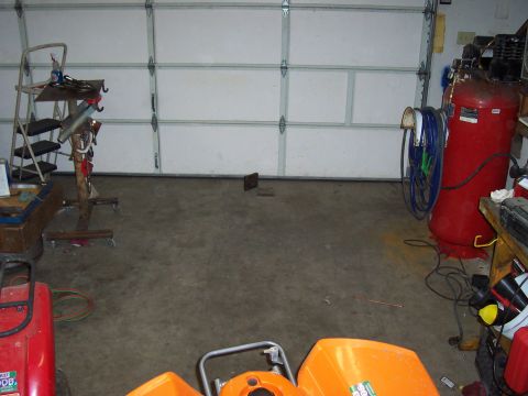 1994 Ford F-150 - A garage scene shows an air compressor, ladder, and other equipment, with a closed garage door in the background.