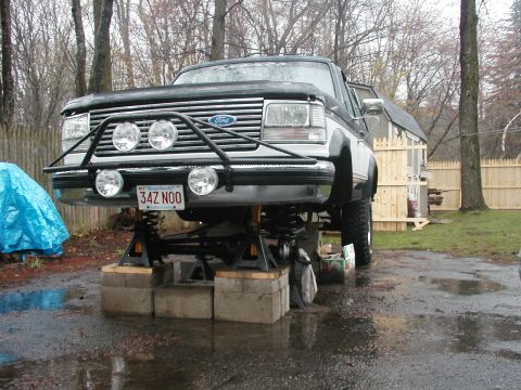 1994 Ford Bronco - This 1994 Ford Bronco is elevated on jack stands, revealing its undercarriage and suspension components.