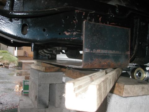 1994 Ford Bronco - Close-up view of a vehicle's undercarriage, with the frame elevated on blocks.