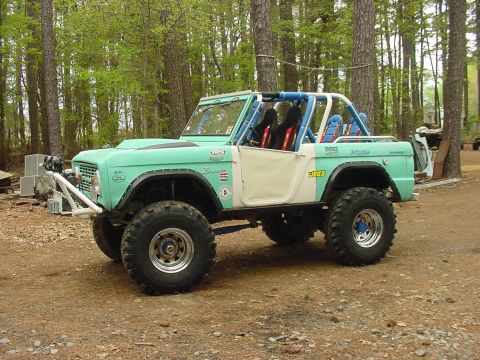 1969 Ford Bronco - This modified Ford Bronco features a roll cage and large off-road tires, suggesting it's built for terrain.