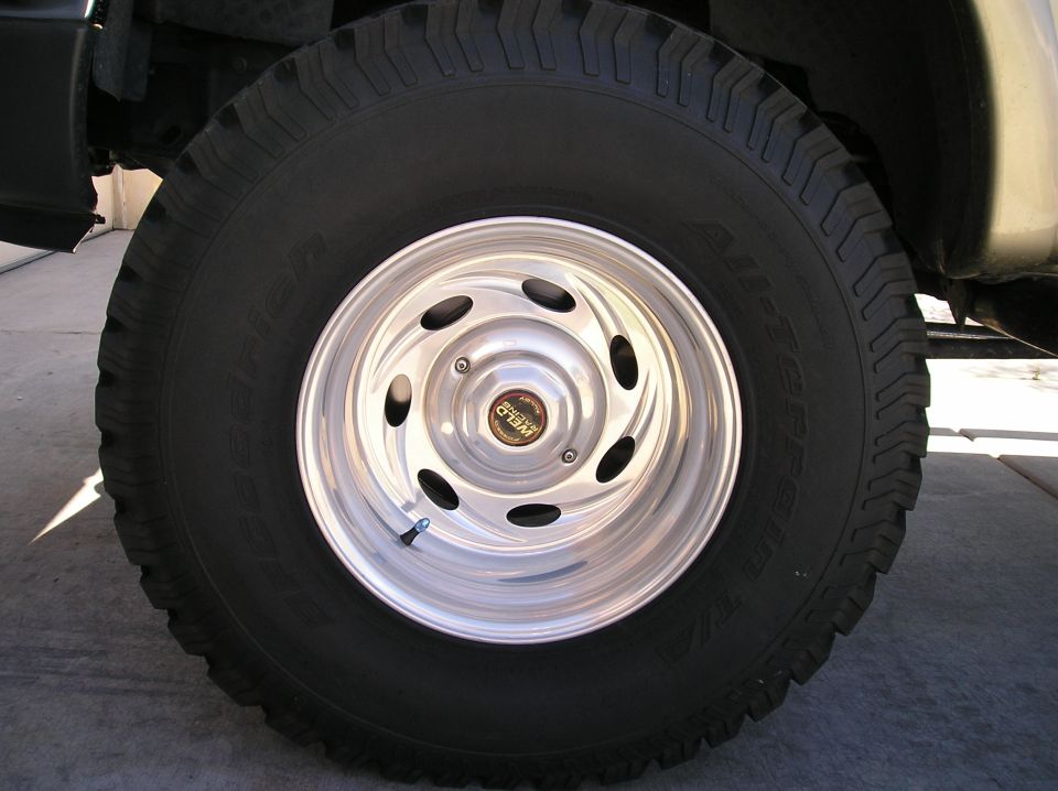 Close-up of a shiny Weld racing wheel on a truck tire