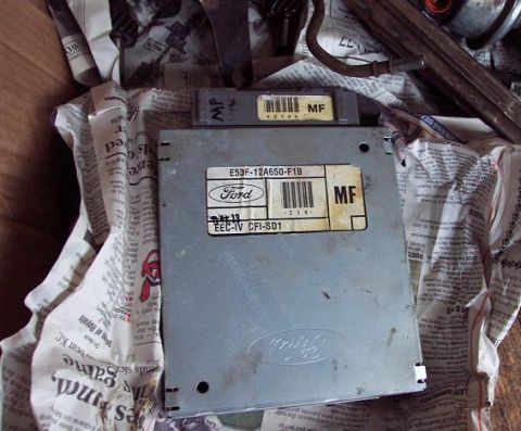 1985 Ford Crown Victoria LTD - A Ford engine control unit is shown, wrapped in newspaper.