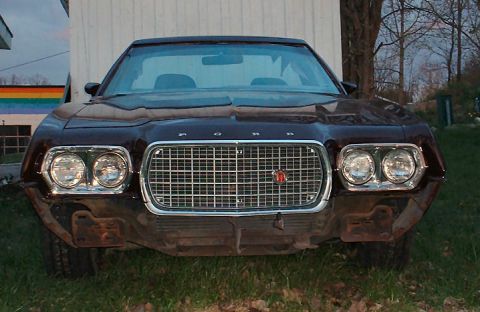 1972 Ford Ranchero - Frontal view of a dark brown 1972 Ford Ranchero with a chrome grille and dual headlights.