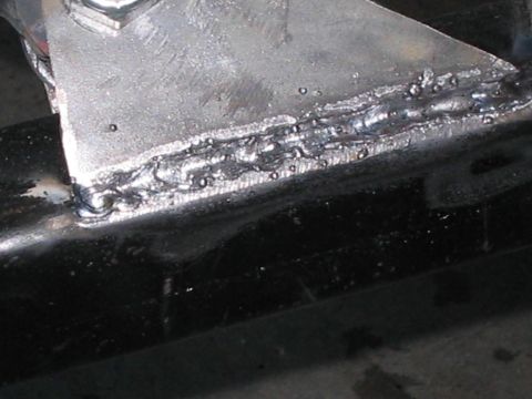 1991 Ford Bronco - A close-up view shows a poorly executed weld on a metal bracket, suggesting a repair or custom modification.