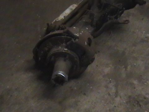 1986 Ford Bronco - Close-up of a vehicle's front axle assembly part, showing the hub and brake rotor.