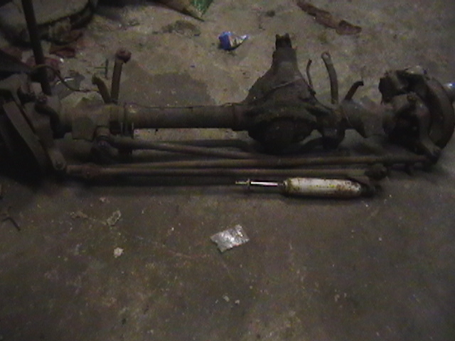 Front axle assembly and a shock absorber on the ground