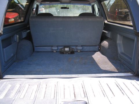 1979 Ford Bronco - Rear cargo area of a Ford Bronco, with a second vehicle visible in the background.