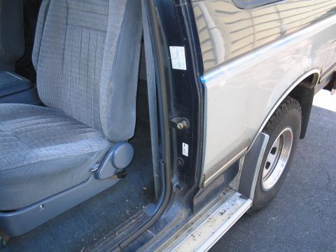 1979 Ford Bronco - The interior of a Ford Bronco, showing the driver's seat and the door jamb area.