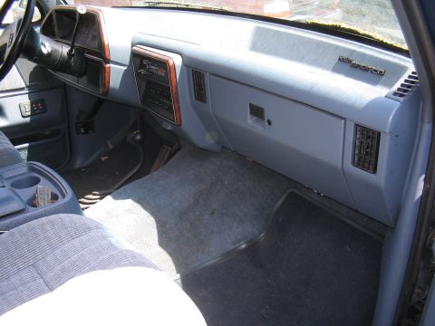1979 Ford Bronco - Interior of a vehicle showing the dashboard, steering wheel, and passenger seat.