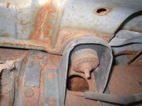 1979 Ford Bronco - Close-up view of heavily rusted undercarriage components, showing significant corrosion on metal parts.