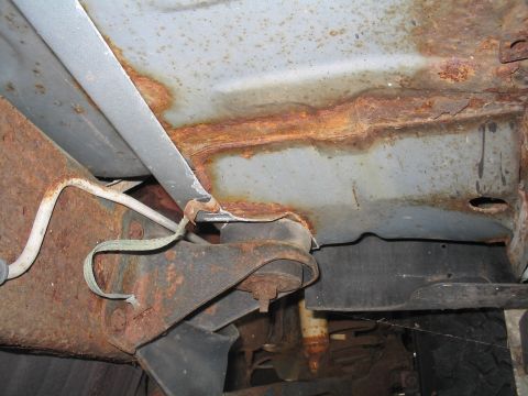 1979 Ford Bronco - Extensive rust is visible on the underbody of this vehicle, affecting the frame and body panels.
