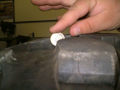 1995 Ford F-150 - A coin is placed on a tire to demonstrate tread depth.