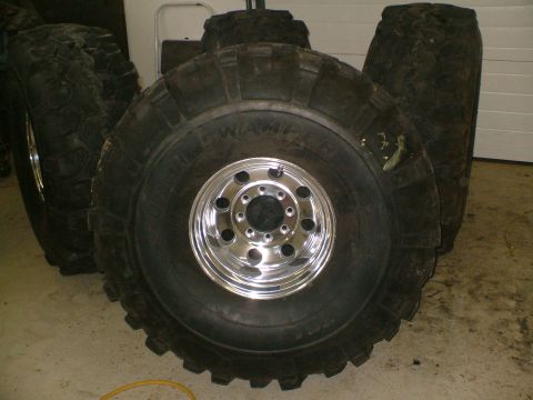 1995 Ford F-150 - Oversized off-road tires and chrome rims are displayed, not a 1995 Ford F-150.